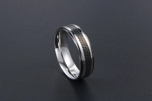 Detail of titanium steel ring featuring gray honeycomb mesh and polished silver edges