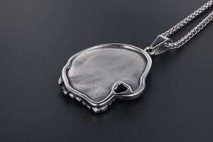 Macro shot of the vintage eagle skull pendant back showing aged silver texture and detail