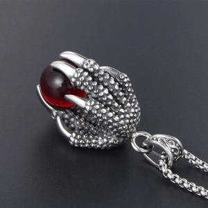 Retro stainless steel dragon claw necklace featuring a translucent red bead pendant