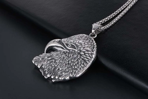Macro view of men's titanium eagle head pendant with detailed feather texture