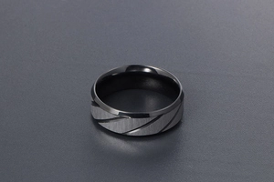 Detail of blue and silver men's titanium steel ring with brushed finish and diagonal grooves