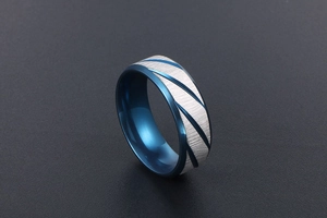 Detailed view of two-tone men's ring with blue inner band and brushed silver finish
