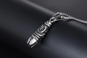 Macro view of gothic engraved titanium steel pendant with silver box chain texture