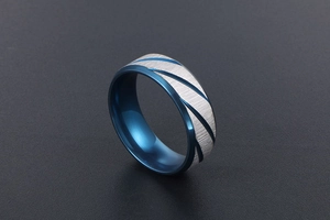 Detail of blue and silver dual-tone titanium steel ring with brushed metal texture