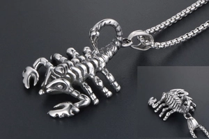 Detailed view of the silver scorpion pendant with intricate textures and box chain
