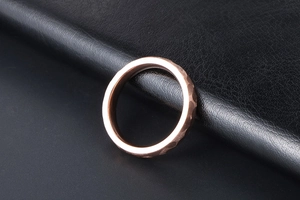Macro shot of rose gold titanium ring featuring a detailed handcrafted hammered texture