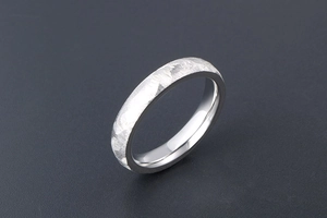 Macro detail of silver ring featuring hand-hammered texture and polished inner surface