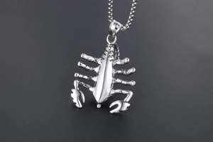 Close-up of polished stainless steel scorpion pendant necklace with punk style details