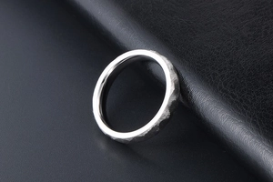 Macro detail of silver hammered texture ring with a smooth polished inner surface