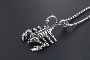 Detailed macro shot of silver scorpion pendant with box chain in stainless steel