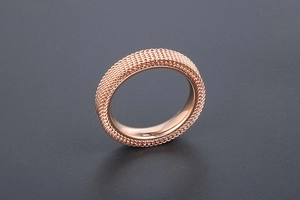 Macro detail of rose gold mesh ring band showing intricate woven texture and polished inner edge