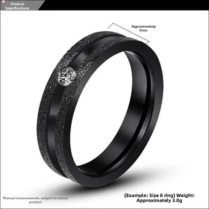 Close-up of 5mm matte black titanium ring featuring a single cubic zirconia stone