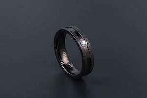 Macro shot of matte black stainless steel ring showing interior 316L engraving and gemstone