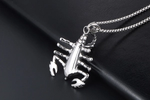 Detailed view of 3D scorpion pendant in polished stainless steel on black leather