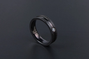 Detail of matte black 316L stainless steel ring with polished groove and cubic zirconia