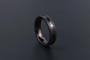 Close-up of black 316L stainless steel ring featuring sandblasted finish and center zircon