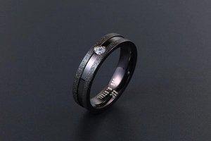 Macro shot of matte black 316 stainless steel ring with a single clear zircon stone