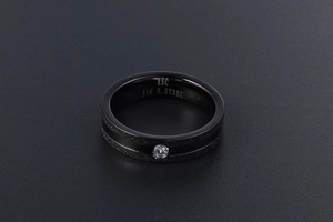 Detailed macro view of black matte stainless steel ring featuring a centered zircon stone