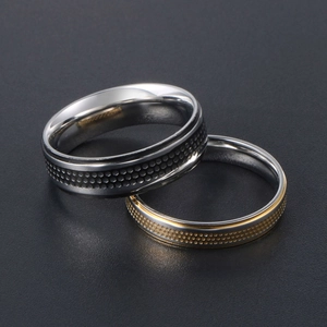 Polished titanium steel couple rings with gold and black honeycomb textured patterns