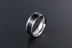 Close-up of titanium steel ring featuring a polished silver surface and black inlay