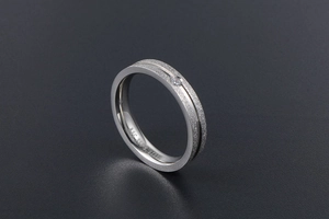 Detailed close-up of matte silver 316L stainless steel ring with a small round crystal