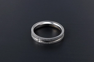 Macro shot of S925 sterling silver ring with frosted finish and single zircon gemstone