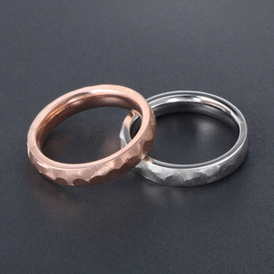 Polished rose gold and silver titanium steel rings with textured hammered finish