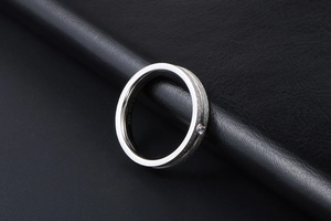 Macro shot of 316L stainless steel ring with matte finish and inset diamond detail