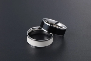 Macro detail of titanium steel rings with black and white drip glue enamel finishes