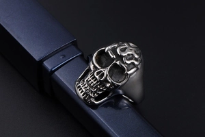 Macro close-up of gothic flame skull ring with detailed vintage silver finish