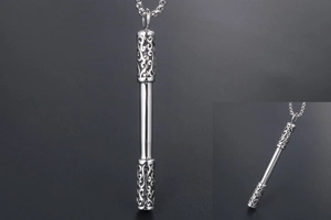 Detailed close-up of Ruyi Jingu Bang pendant with ornate engraved ends on silver chain