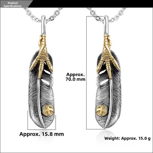 Close-up of vintage feather pendant with eagle claw detail and engraved bird logo