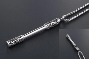 Macro detail of stainless steel Ruyi Jingu Bang pendant with ornate cloud carvings