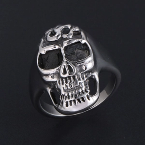 Gothic flame skull ring in antique steel finish with textured black lava stone eye sockets