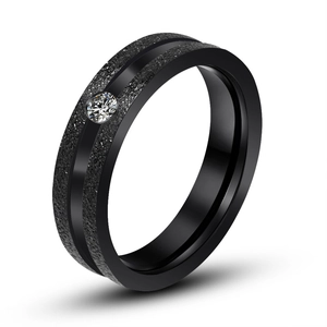 Matte black titanium steel ring for couples featuring a single sparkling center diamond