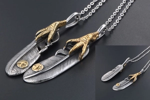 Detailed view of vintage eagle claw feather pendants on a retro metallic chain link