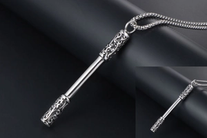 Detailed view of silver stainless steel staff pendant with intricate cloud patterns and chain