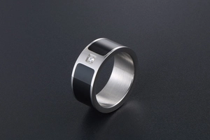 Macro shot of silver titanium ring with black enamel inlay and single CZ diamond detail