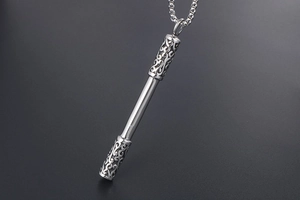 Close-up of silver steel staff pendant necklace with intricate hollow cloud patterns