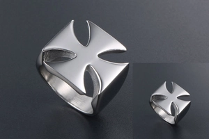 Macro detail of silver stainless steel wide band ring with hollowed cross pattern
