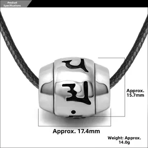 Macro view of a titanium steel cylinder charm with engraved mantra and dimensions