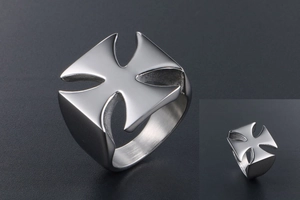 Detailed close-up of a silver stainless steel ring with a cross cutout and polished finish
