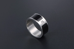 Detail of titanium steel band with black enamel inlay and centered cubic zirconia stone