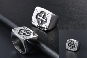 Macro view of men's stainless steel signet ring with vintage cross and floral corner details