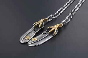 Close-up of vintage feather pendants with eagle claw details and intricate textures