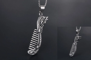 Macro view of vintage silver dragon comb pendant with intricate metallic carvings