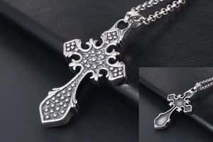 Detailed macro view of vintage gothic cross pendant with textured relief patterns