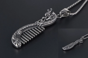 Detail of vintage dragon comb pendant in titanium steel with intricate scale textures