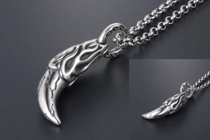 Detailed view of silver titanium steel wolf tooth pendant with flame pattern and cracks