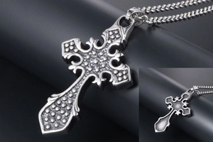 Macro view of gothic cross pendant featuring embossed patterns and matte back finish